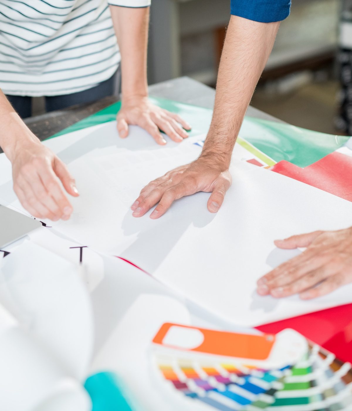 Colleagues of printing house touching paper Colleagues of printing house touching paper